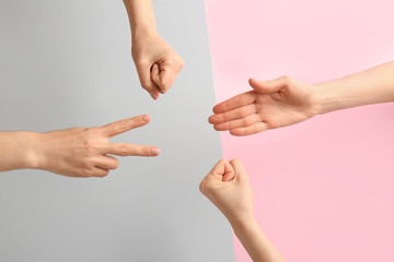 People playing roshambo game on color background