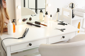 Table with mirror and supplies in hairdresser salon