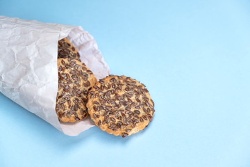 Heap of cookies with flax seeds on blue background