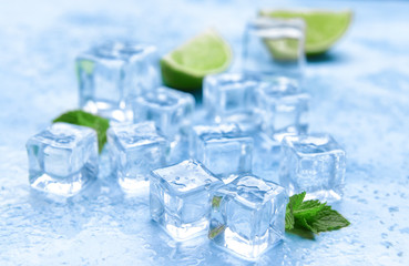 Ice cubes, lime and mint on color background