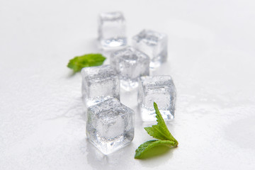 Ice cubes and mint on white background