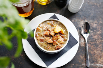 Traditional Polish sour rye soup with sausage and potatoes. Appetizing soup. Suggestion to serve the dish. Culinary photography.