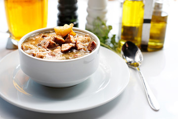  White borscht with sausage and potatoes. Appetizing soup. Suggestion to serve the dish. Culinary photography.