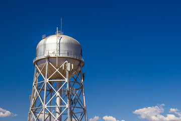 Round Metal Water Tank With Communication Antennas Attached
