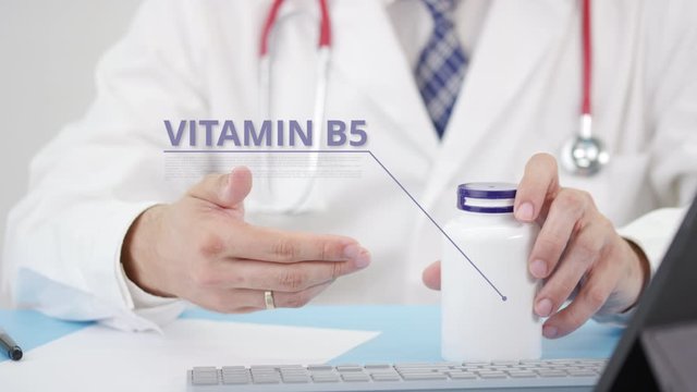 VITAMIN B5, a generic supplement, in the bottle in doctor's hand