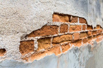 Big crack on concrete wall, old brick wall background, outdoor day light