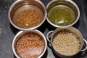 Fresh green gram beans and peanuts with channa dal on black background