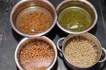Fresh green gram beans and peanuts with channa dal on black background
