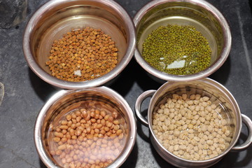 Fresh green gram beans and peanuts with channa dal on black background