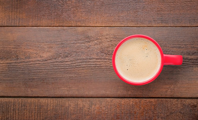 mug with hot coffee on wooden background