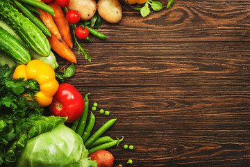 Assortment of fresh vegetables on wooden table background. Healthy organic food grocery concept. Copy space