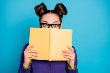 Close-up portrait of her she nice attractive smart clever funny shy schoolgirl hiding behind diary book home task isolated on bright vivid shine vibrant blue green teal turquoise color background