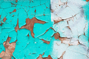 Peeling turquoise paint on a concrete wall. Blue and white painted abstract backgrounds, cracked...