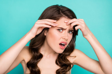 Obraz premium Close-up view portrait of her she nice attractive irritated wavy-haired teen girl touching clean clear sensitive forehead isolated bright vivid shine vibrant green turquoise color background