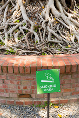 A smoking area sign on the ground.