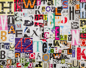 Colorful abstract collage from clippings with letters and numbers texture background. Torn and...