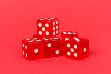 Transparent and red glass dices isolated on red background.