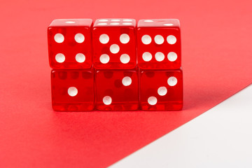 Transparent and red glass dices isolated on red and white background.