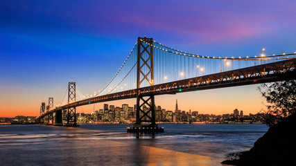 San Francisco skyline and Bay Bridge at sunset, California