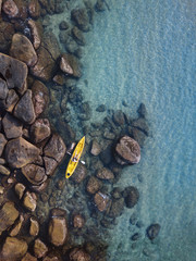 adventure travel, kayaking on tropical beach, man paddling on kayak aerial top down view from above