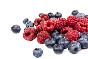 raspberries and blueberries isolated on white background