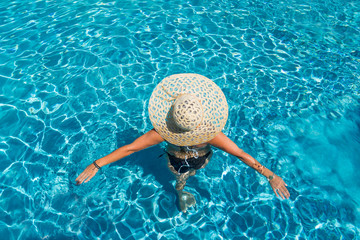 woman in luxury spa resort near the swimming pool.