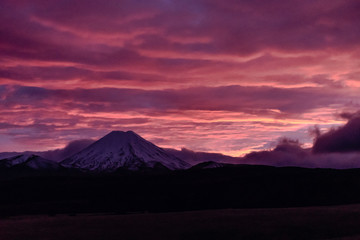 Beautiful pink and purple cloudy sunrise over the snowy mountains in New Zealand