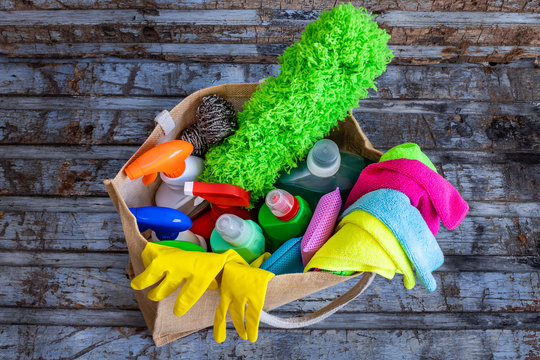 Many cleaning materials in the plastic bottles on the table