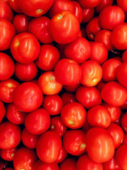 Delicious red ripe tomatoes lie in a bunch. View from above. Background image.