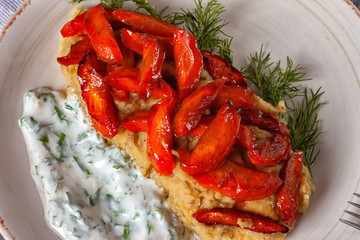 Caramelized carrots garnished with lentils and yogurt-based sauce