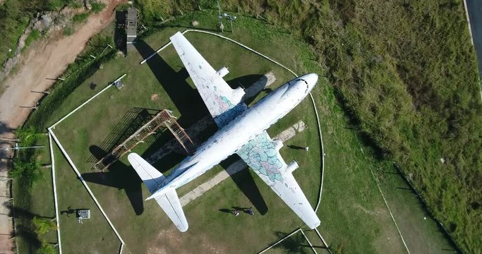Drone going up with camera pointed down on top of a big old plane, open air museum of aviation, cinema, magic, in 4K resolution Vickers Viscount Rolls Royce