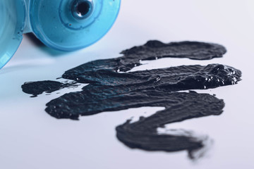 Black charcoal face mask or scrub isolated on a white background. Face care concept.
