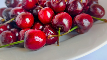  Red sweet berries on a plate. Vegetarian food for health. Selective focus