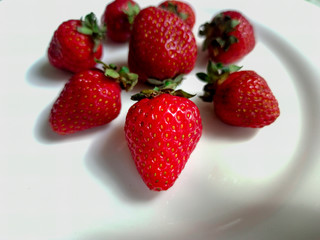  Appetizing fresh strawberries on a white plate. Vegetarian, healthy lifestyle