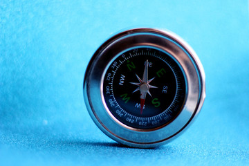 compass on an abstract blue background with bokeh. Photo