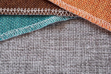 Gray, green, brown and orange textiles. Fabric for decoration, embroidery, backgrounds and creative works