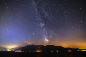 Naklejka na ściany i meble night sky with stars and clouds over the lake