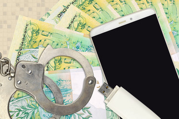 50 Belorussian rubles bills and smartphone with police handcuffs. Concept of hackers phishing...