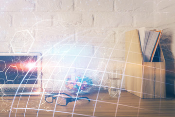 Double exposure of desktop with computer and world map hologram. International data network concept.
