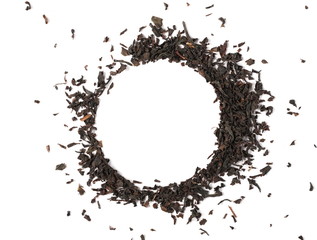 Dry black tea leaves round frame and border pile isolated on white background and texture, top view