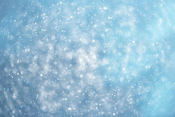blue snowfall bokeh background, abstract snowflake background on blurred abstract blue