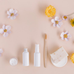 Fototapeta na wymiar Travel size body care products mock up, organic soap, toothbrush on beige background. Creative still life composition.