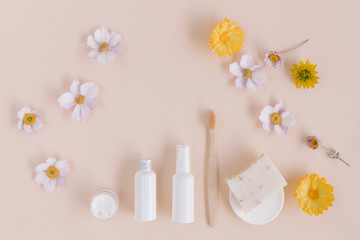 Top view of organic soap, eco friendly toothbrush and body care products mock up on beige background.