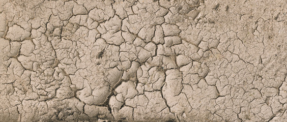 Background Of Brown Dry Cracked Soil Dirt Or Earth During Drought. Dry Cracked Earth Depicting Severe Drought Conditions. Panorama