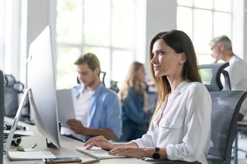 Woman working on computer at modern office