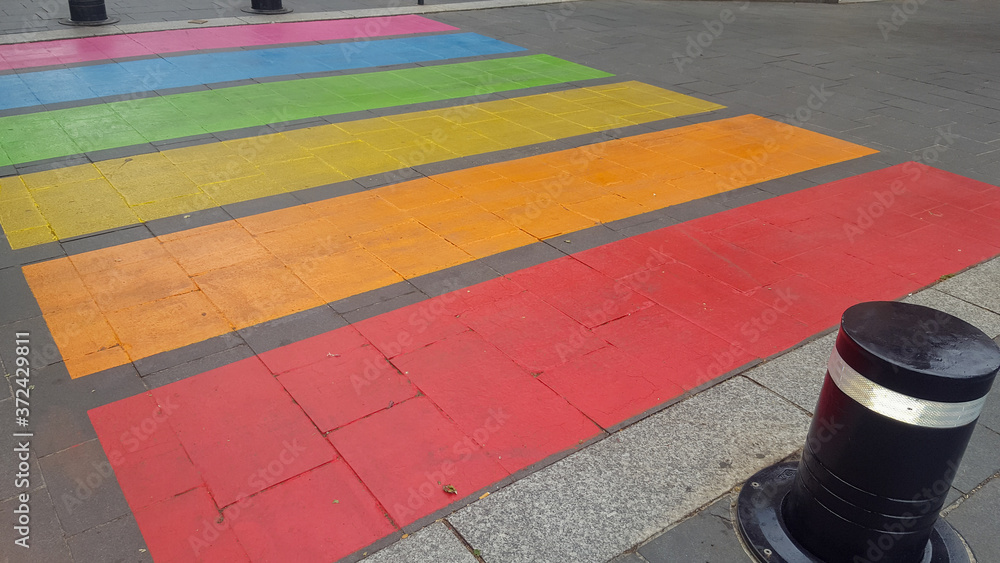 Wall mural pedestrian crossing in colors rainbow flag sign to sex discrimination concept of the lgbt community