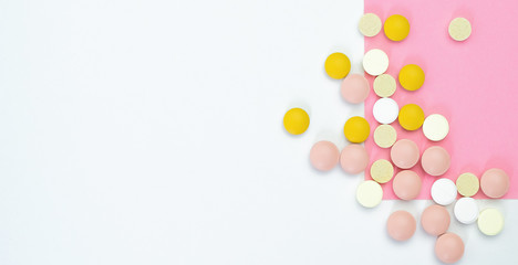 Pile of Pills colorful on a white - pink background