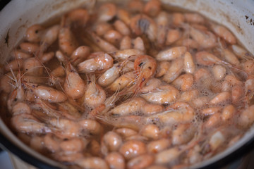 cooking in a pan of sea shrimp, cooking, hot, grilled shrimp, tasty and delicious dish, barbecue, seafood, close up, top view