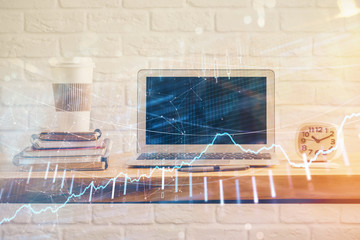 Stock market graph and table with computer background. Multi exposure. Concept of financial analysis.