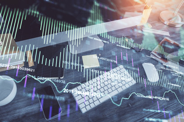 Double exposure of graph and financial info and work space with computer background. Concept of international online trading.